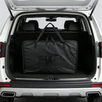 Sac de transport pour table de massage rangé dans un coffre de voiture